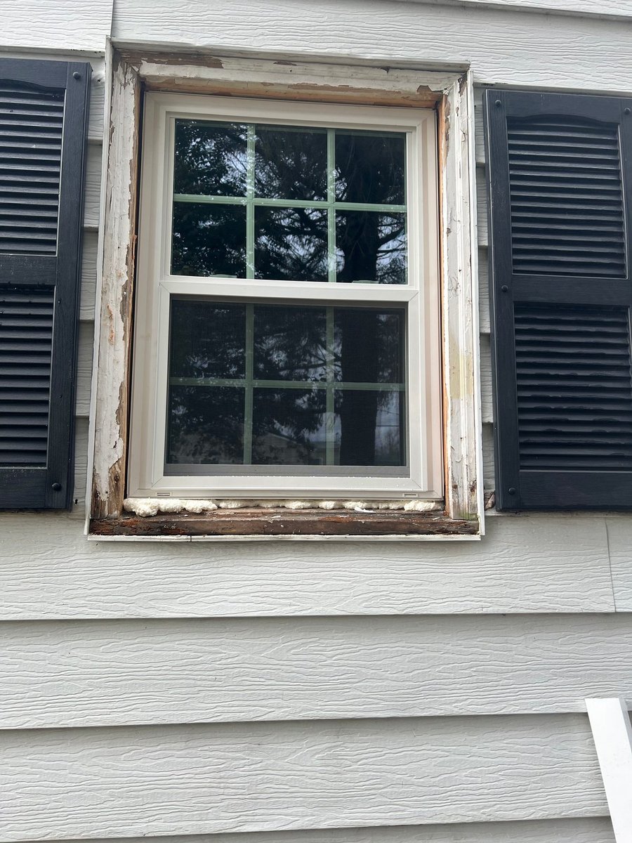 Window before repair — rotted sill and brickmould